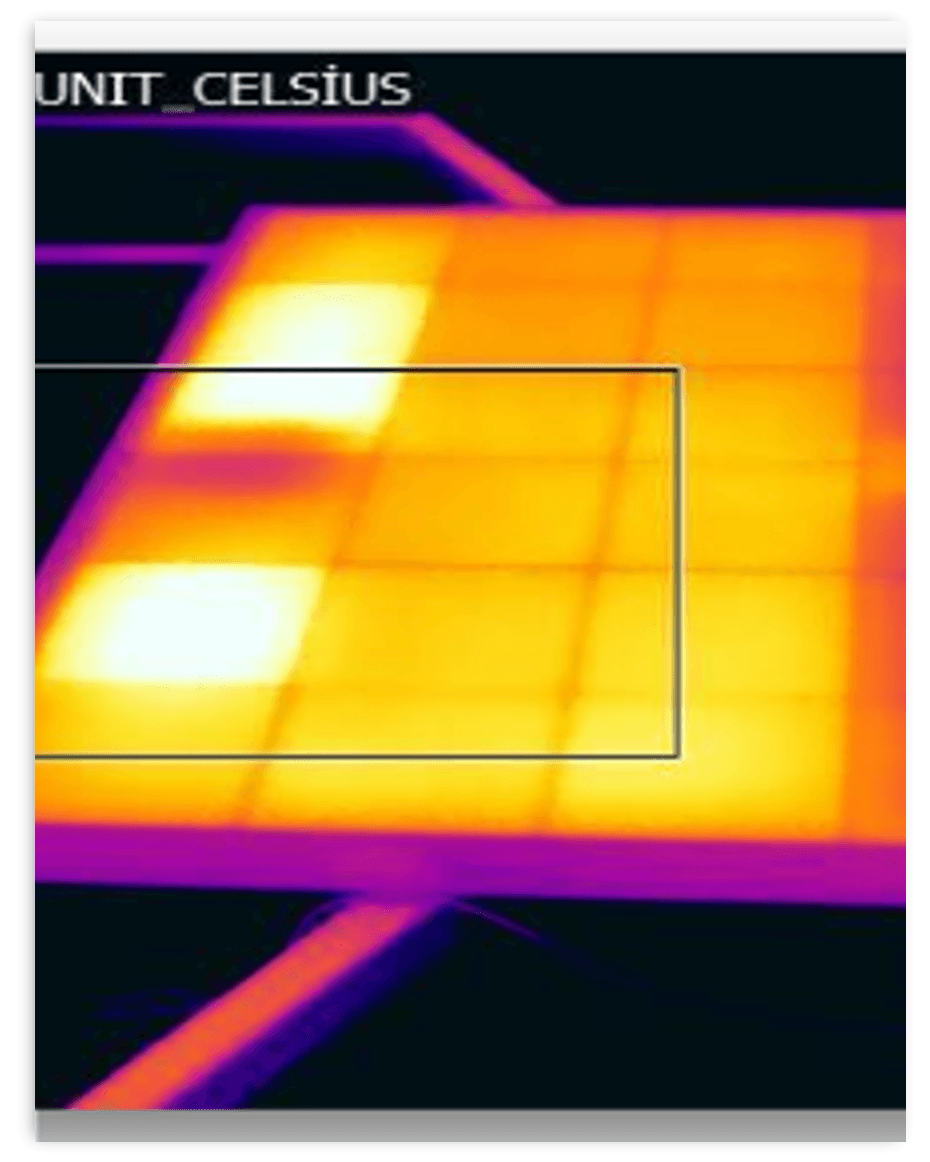 Thermal image from the hot-spot endurance test showing two bright hot cells on a module