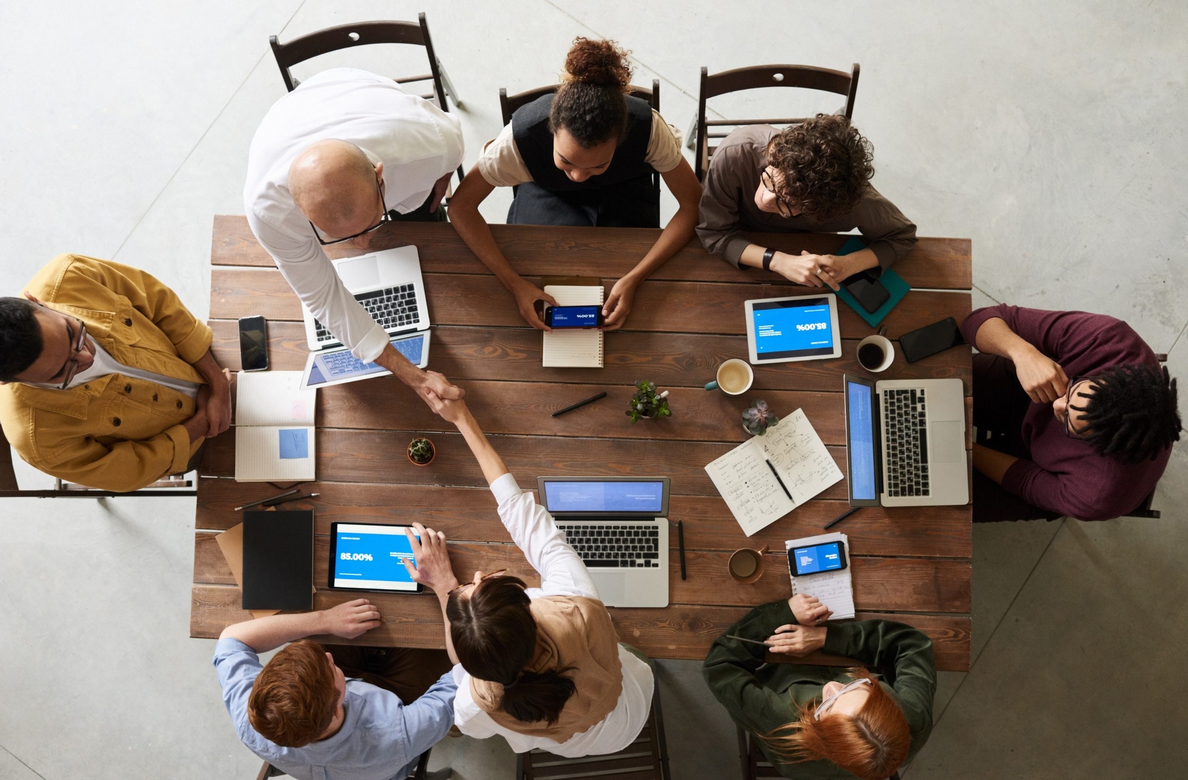 A team working together around a table, seen from above